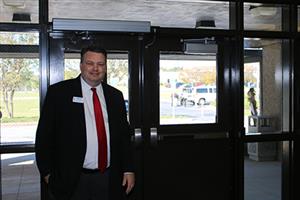 Dr. Ray at the front of the school. 